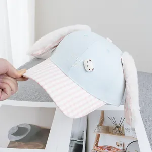 Detail of baby baseball cap with plush long rabbit ears and Let's go embroidery