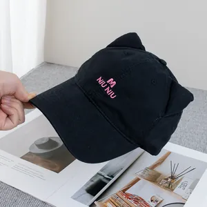 Close-up of black cotton baseball cap with cute cat ears and pink letter embroidery
