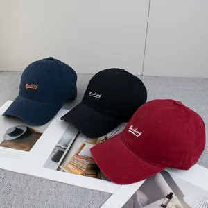 Three cotton baseball caps in navy, black, and red with Backing embroidery and curved brim