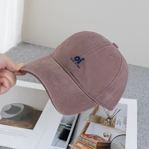 Detailed embroidery on a dusty rose cotton baseball cap with Oi look at me text