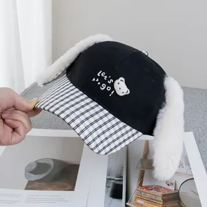 Detail of cute long plush rabbit ears and checkered brim on a black baseball cap