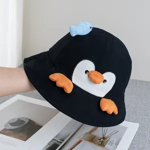 Detail of cute penguin bucket hat with 3D blue fish ornament and orange webbed feet