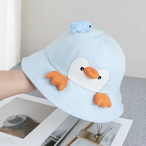 Detailed close-up of light blue penguin bucket hat for kids with 3D fish and orange beak