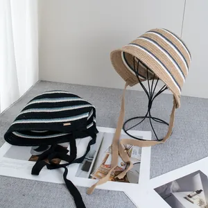 Detail of vintage striped knit bucket hat featuring delicate hand-woven ties and soft texture