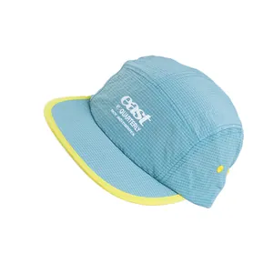 Light blue ripstop 5-panel baseball cap with yellow brim trim and embroidered letters
