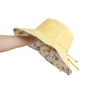 Double-sided floral sun hat in bright yellow with wide brim and adjustable chin strap