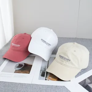 Detailed embroidery of letters on soft cotton baseball caps in multiple colors