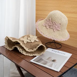 Handwoven straw sun hat with flower accents and wide brim for beach summer protection