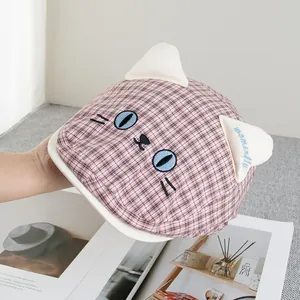 Close-up of pink plaid newsboy hat featuring 3D cat ears and blue embroidery detail