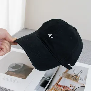 Close-up of white letter embroidery and EST1938 text on a black cotton baseball cap