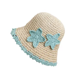 Handmade woven sun straw hat with blue star patterns and a wide brim for beach wear