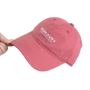 Pink washed cotton baseball cap with white embroidery shown in a flexible soft top view