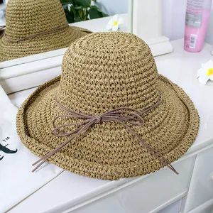 Foldable khaki straw sun hat with ribbon bow tie, perfect for summer beach travel