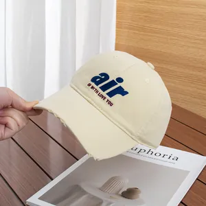 Detail of air embroidery and distressed brim on cotton canvas baseball cap