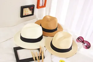 Three wide-brim straw sun hats in white, beige, and tan with black bands for summer beach