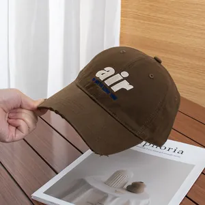 Detail of vintage brown baseball cap featuring 3D towel embroidery and distressed brim