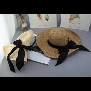 Women's wide brim straw sun hats with black ribbons in beige and khaki shades
