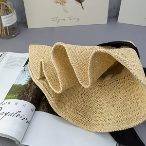 Elegant beige straw hat with black brim ribbon for summer beach sun protection