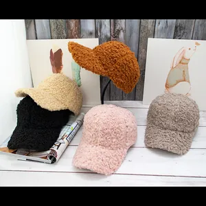 Winter faux lamb wool baseball caps in five colors on a wooden background with magazines