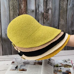 Detailed texture of stacked knit equestrian hats in yellow, khaki, black, and beige