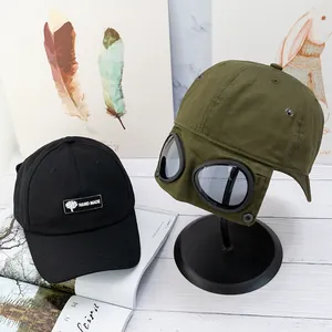 Détail d'une casquette en coton avec lunettes et écusson sur une surface en bois