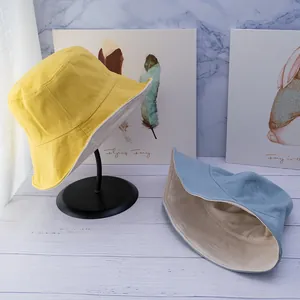 Double-sided cotton bucket hat in yellow and light blue colors with a wide stitched brim