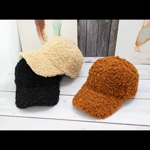 Detailed texture of thick plush teddy fleece baseball caps in black, cream, and brown colors