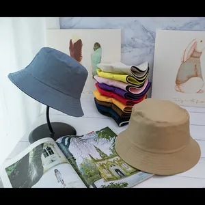 Detail view of colorful cotton bucket hats with reinforced stitching in various trendy shades