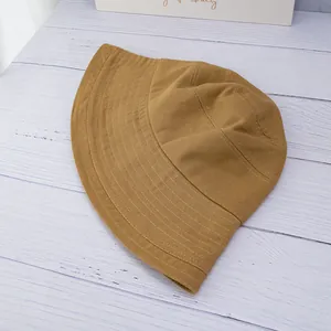 Detailed view of dark camel fisherman hat with parallel stitching on fine cotton twill brim