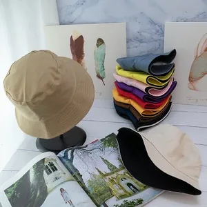 Close-up of stacked multi-color cotton bucket hats with premium textured canvas fabric