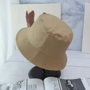 Detail of khaki bucket hat with reinforced stitching on a premium display stand