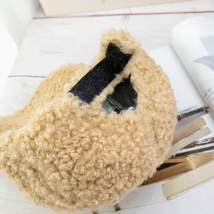 Detail view of beige lamb wool baseball cap with velcro strap and ponytail opening