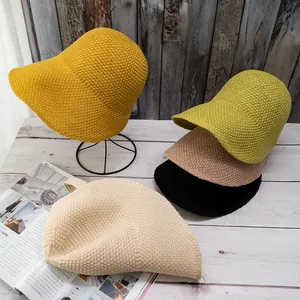 British style knit bucket hat in five colors on vintage wood background