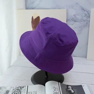 Close-up of a purple cotton bucket hat showing parallel stitching on the brim detail