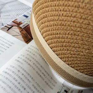 Detailed close-up of the woven straw material texture on a stylish sun visor hat