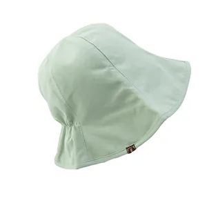 Light green cotton reversible bucket hat for women with small fabric label detail