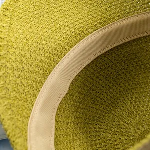 Detail of lime green knit hat interior featuring neat stitching and a beige sweatband