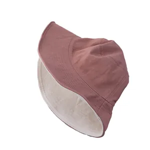 Reversible cotton fisherman bucket hat in rose pink and off-white with sturdy stitching