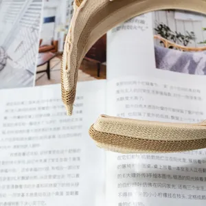 Detailed side view of two-tone beige woven visor headband with straw texture
