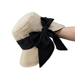 Elegant beige sun hat with a large black bow for UV protection and summer vacations