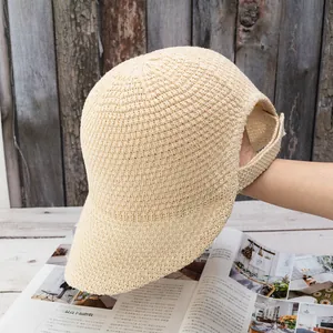 Detail view of the wide-brim knit sun hat with a unique ponytail opening at the back