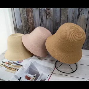 Detailed weave pattern of vintage-style straw bucket hats in various earthy tones
