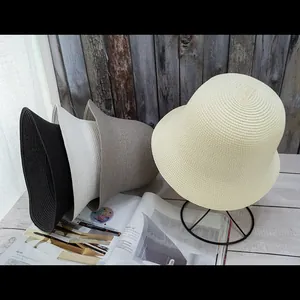 Detailed weave pattern of vintage straw bucket hats in black, white, khaki, and beige