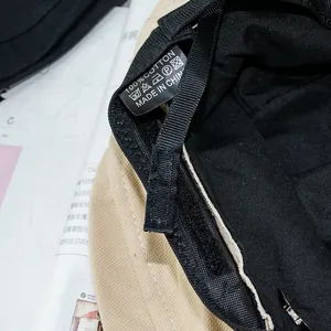 Detail showing the 100% cotton wash care label and inner stitching of the bucket hat