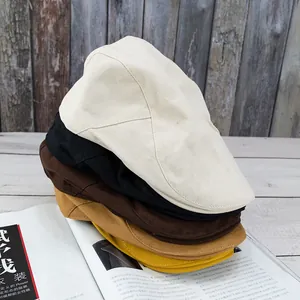 Flat cap detail showing stacked beige black coffee and yellow vintage cotton hats