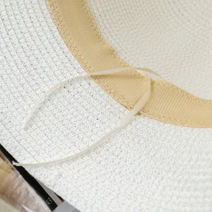 Detailed macro view of the interior woven straw texture and adjustable sizing drawstring