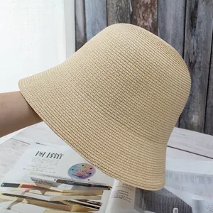 Detailed close-up of the fine woven texture on this beige straw bucket sun hat