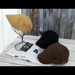 Three retro unisex beret hats in khaki black and brown colors with adjustable metal buckles