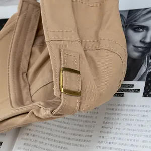 Detail of khaki cotton canvas beret with vintage bronze metal adjustment buckle