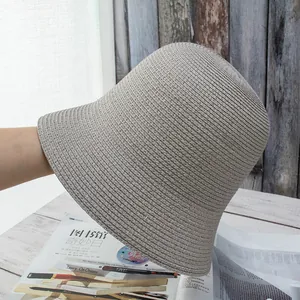 Detailed close-up of light grey straw sun hat with fine silver glitter woven texture